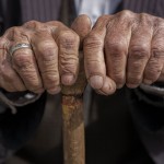 An older man holding a cane