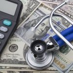 USD notes, stethoscope, calculator