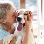 a senior woman at home with her dog