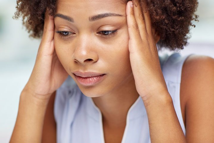 african american woman with headache, looking sad