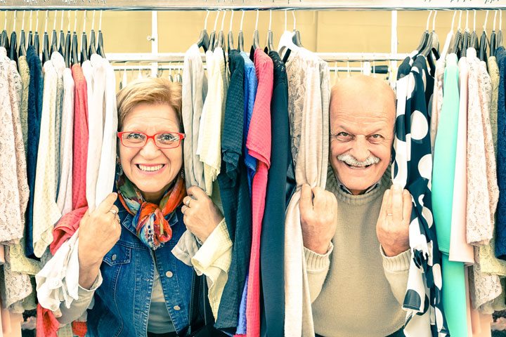 Playful senior couple at weakly flea market - Happy elderly