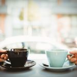 Friends holding cup of coffee