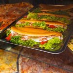 Delicious sandwiches on street fast food showcase.