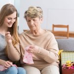 grandma teaching younger woman how to knit
