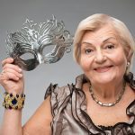 Elderly woman wearing glamorous mask