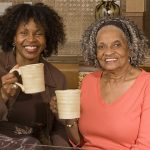 Mother and daughter having coffee
