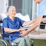 Male caregiver helping senior woman