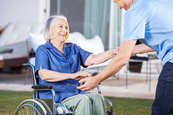 Male caregiver helping senior woman