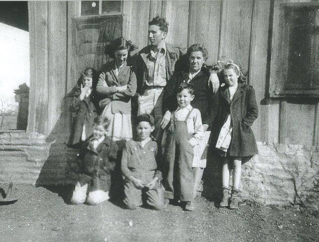 The photo of the family in front of the shack is my momma's family. She is the little girl standing to the far right. 