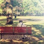 Senior sitting in a park bench