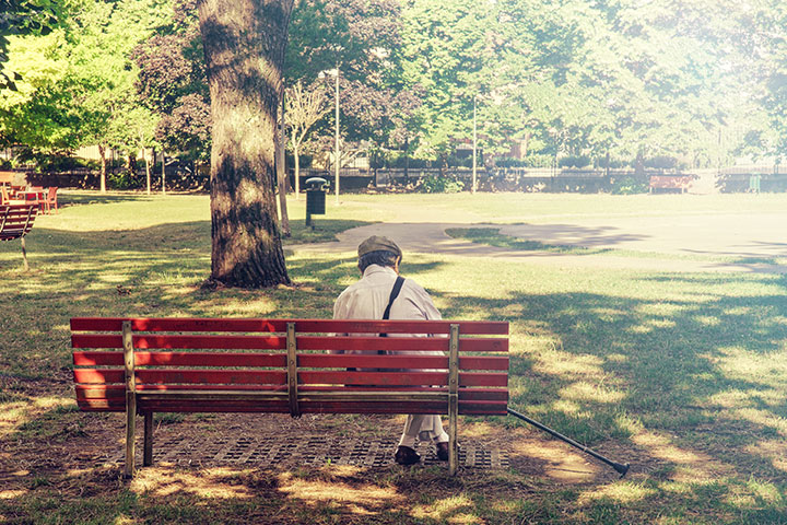 Senior sitting in a park bench