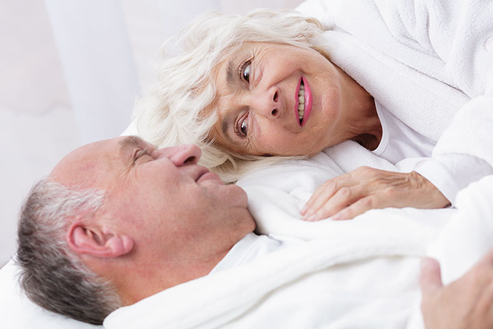 Happy senior couple in bed
