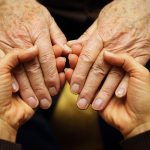 two pairs of hands holding