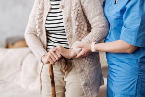 Nurse helps aging person