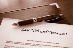 Last will and testament document with brown pen on desk