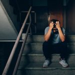 Lonely man sitting on stairs