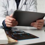 Doctor looking at iPad at desk