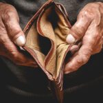Older hands holding an empty wallet