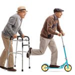 Two elderly men one riding a walker and one riding a scooter