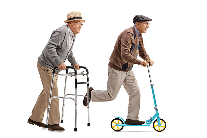 Two elderly men one riding a walker and one riding a scooter