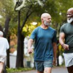 Two older men walking and talking in an urban park like setting